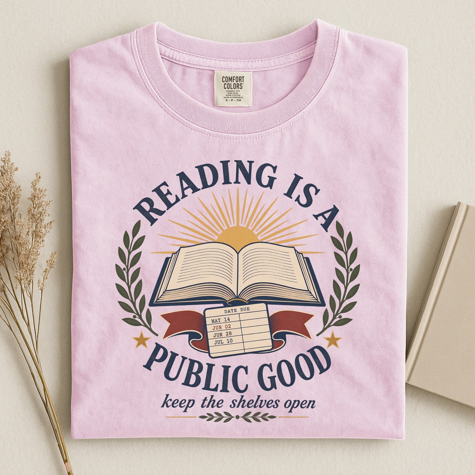 Reading Is a Public Good bookish tee in Blossom, flat lay