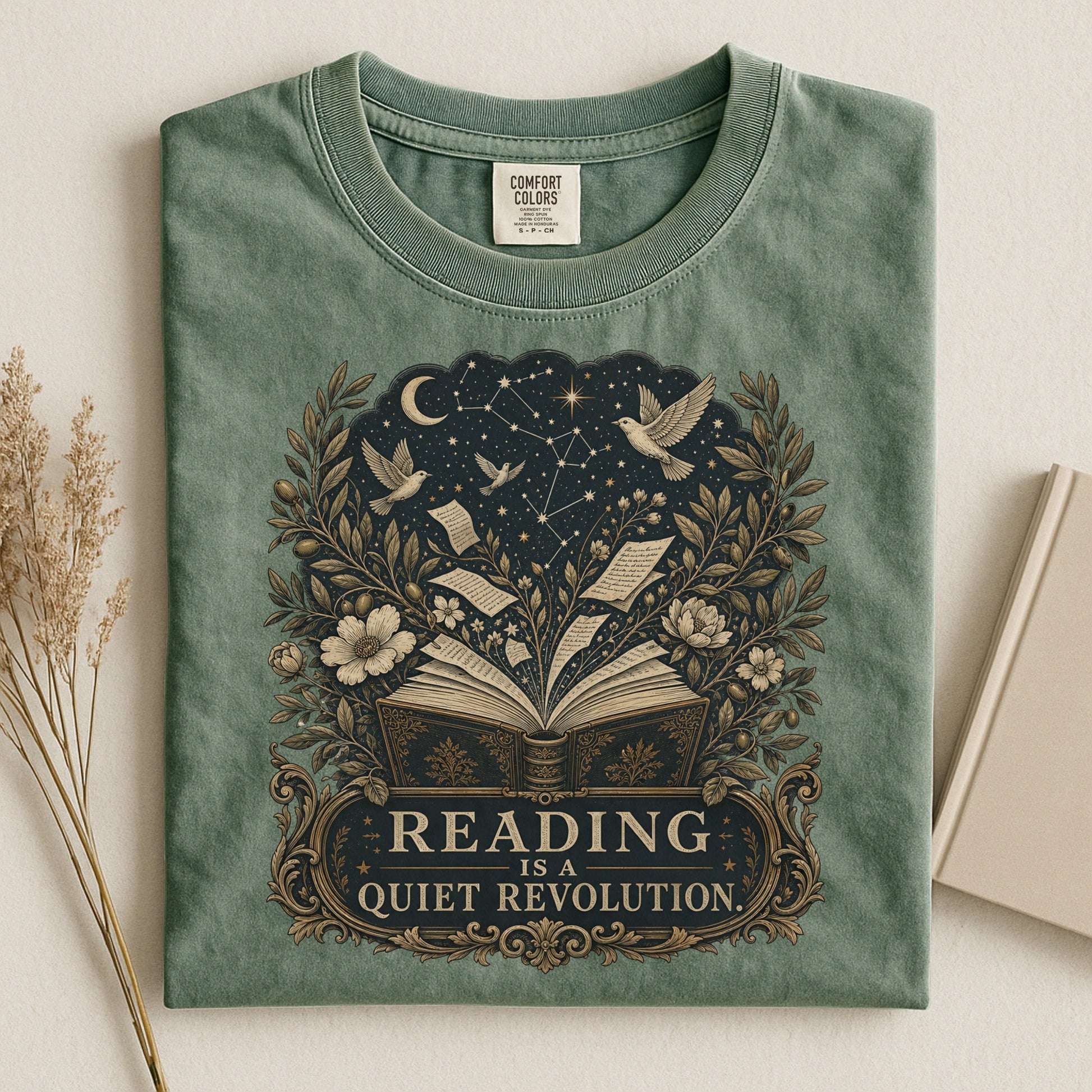 Reading Is a Quiet Revolution bookish tee in Moss, flat lay