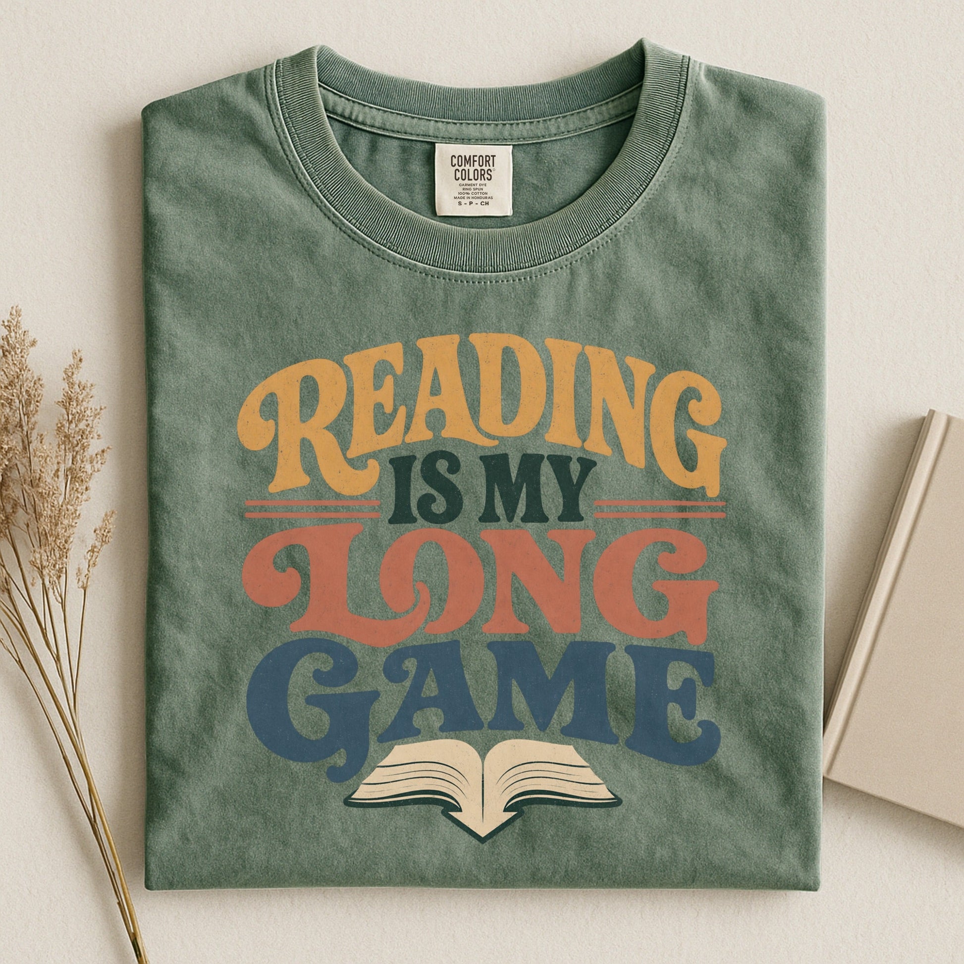 Reading Is My Long Game bookish tee in Moss, flat lay