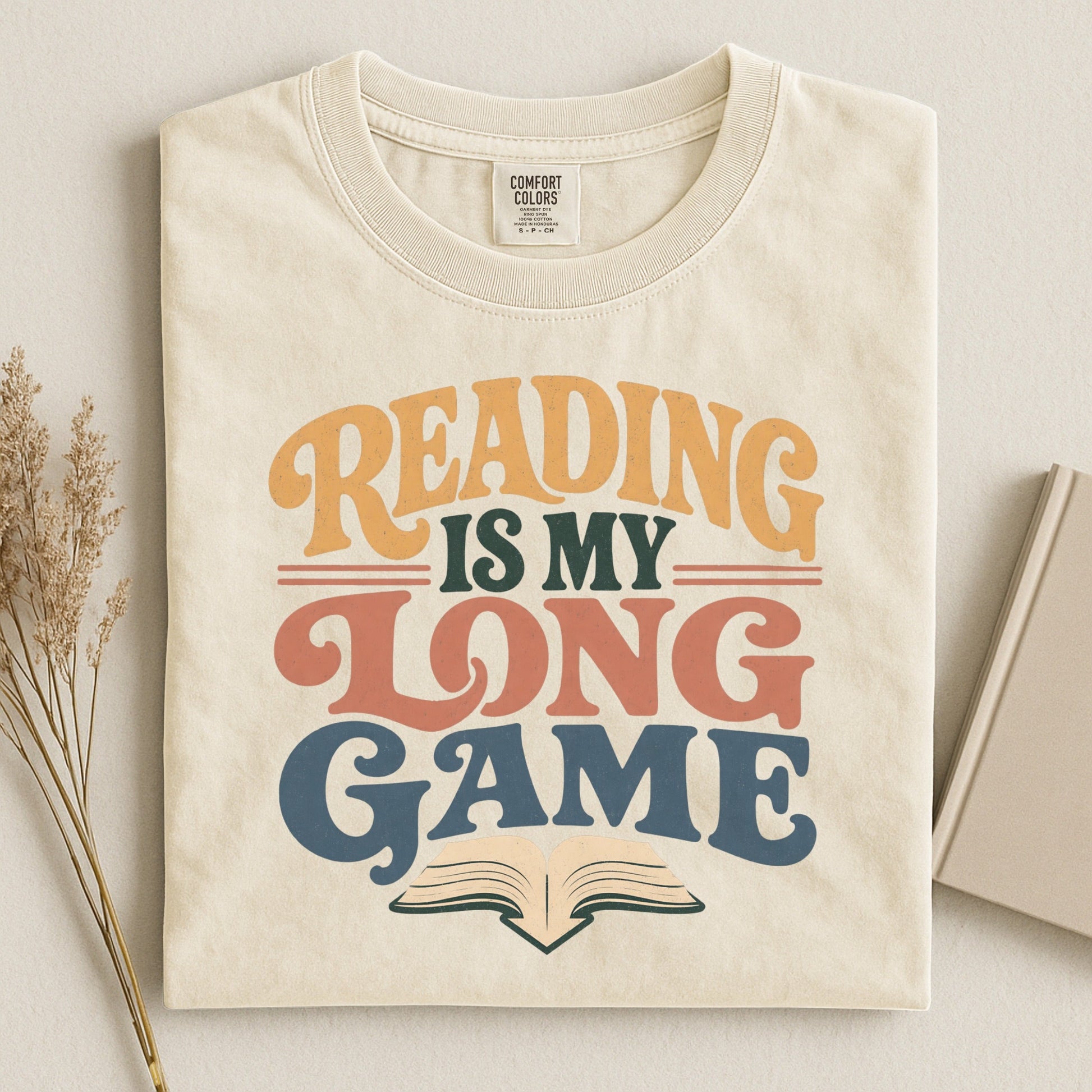 Reading Is My Long Game bookish tee in Ivory, flat lay