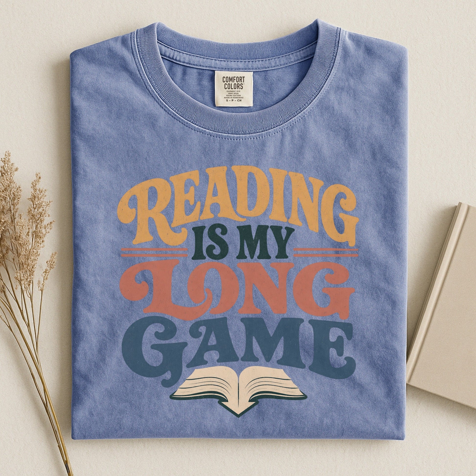 Reading Is My Long Game bookish tee in Blue Jean, flat lay