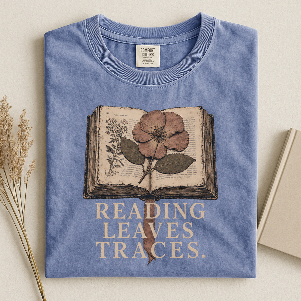 Shelf Love Studio Reading Leaves Traces t-shirt in Blue Jean, styled flat lay