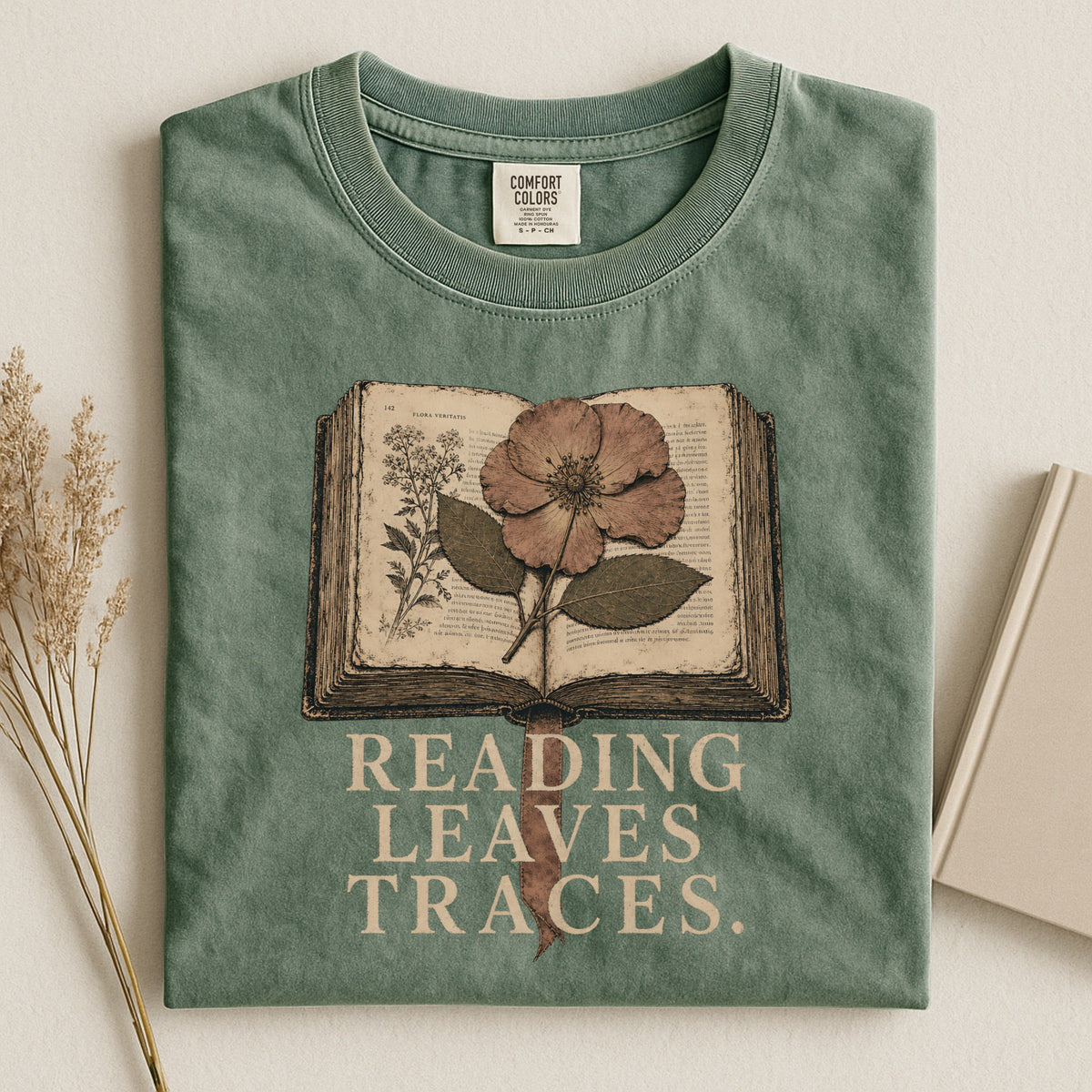 Shelf Love Studio Reading Leaves Traces t-shirt in Moss, styled flat lay