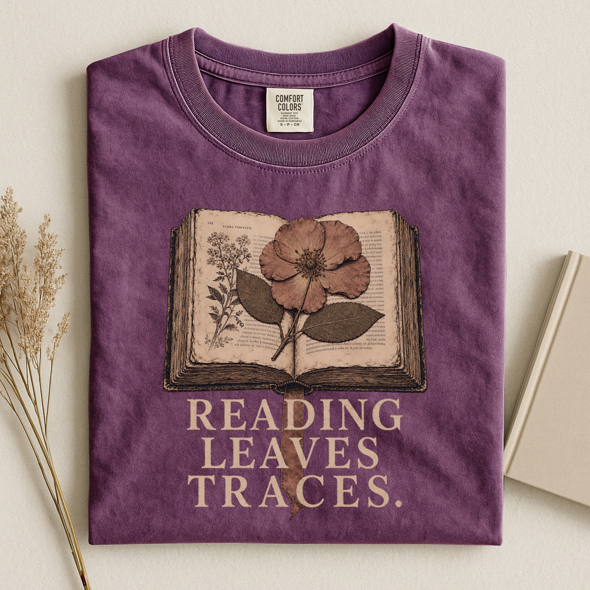 Shelf Love Studio Reading Leaves Traces t-shirt in Berry, styled flat lay