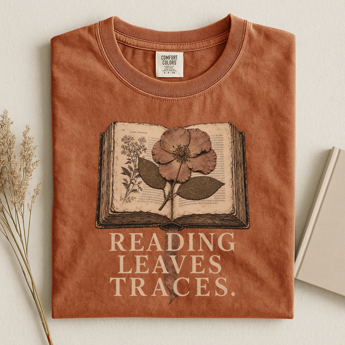 Shelf Love Studio Reading Leaves Traces t-shirt in Yam, styled flat lay
