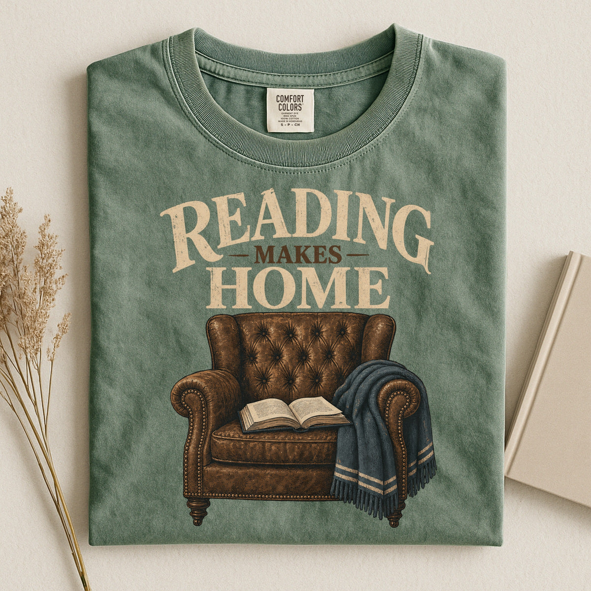 Shelf Love Studio Reading Makes Home t-shirt in Moss, styled flat lay