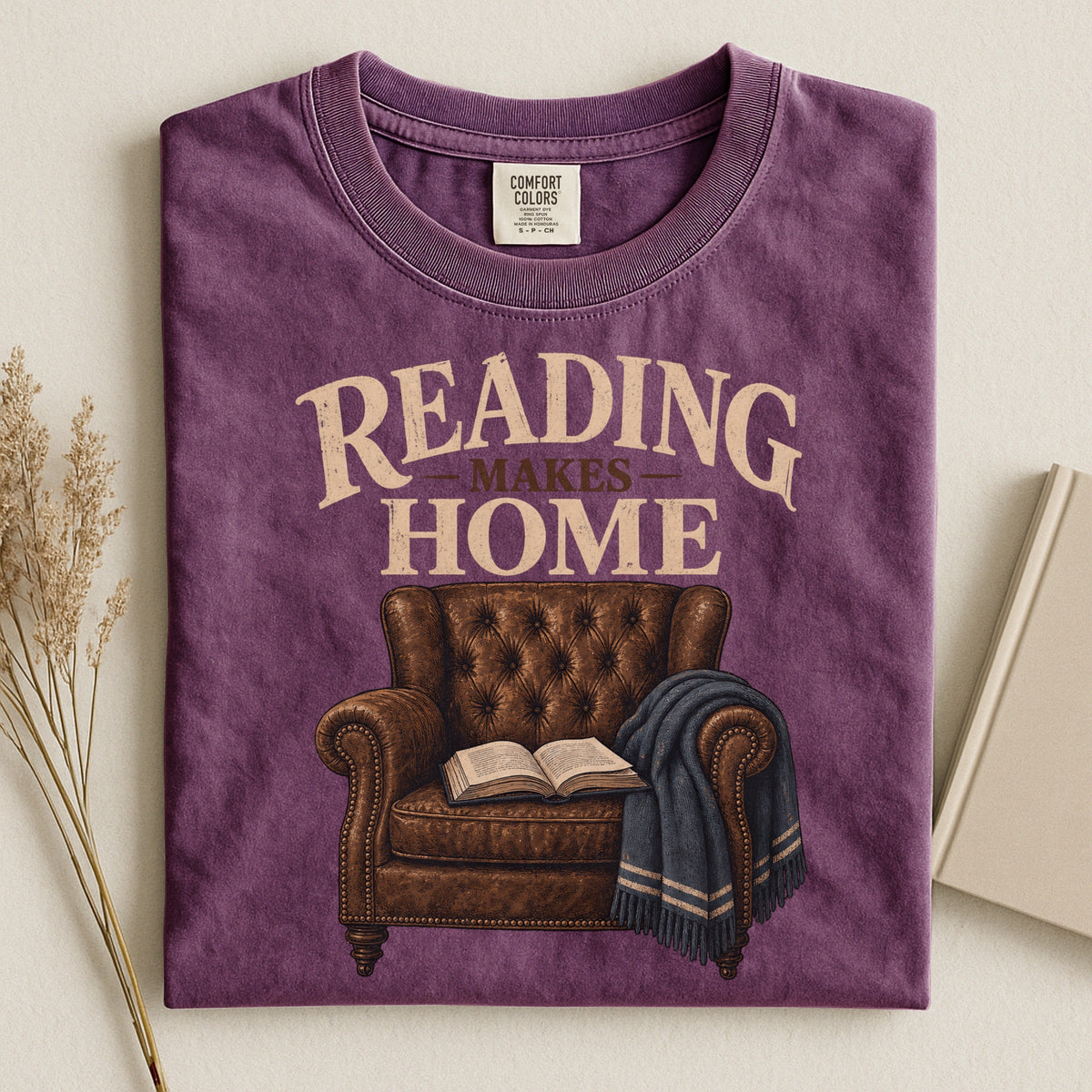 Shelf Love Studio Reading Makes Home t-shirt in Berry, styled flat lay