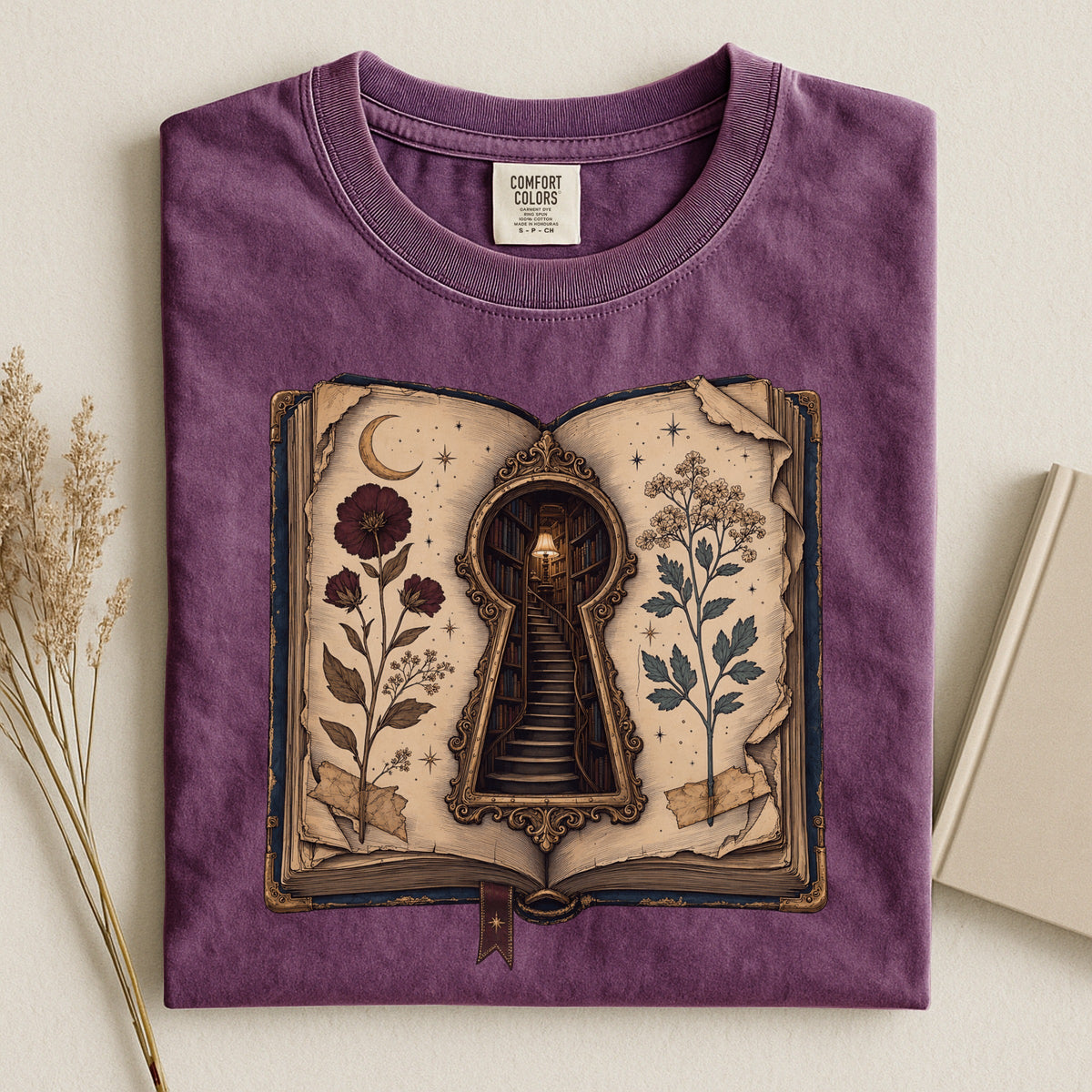 Shelf Love Studio Surreal Keyhole Book t-shirt in Berry, styled flat lay