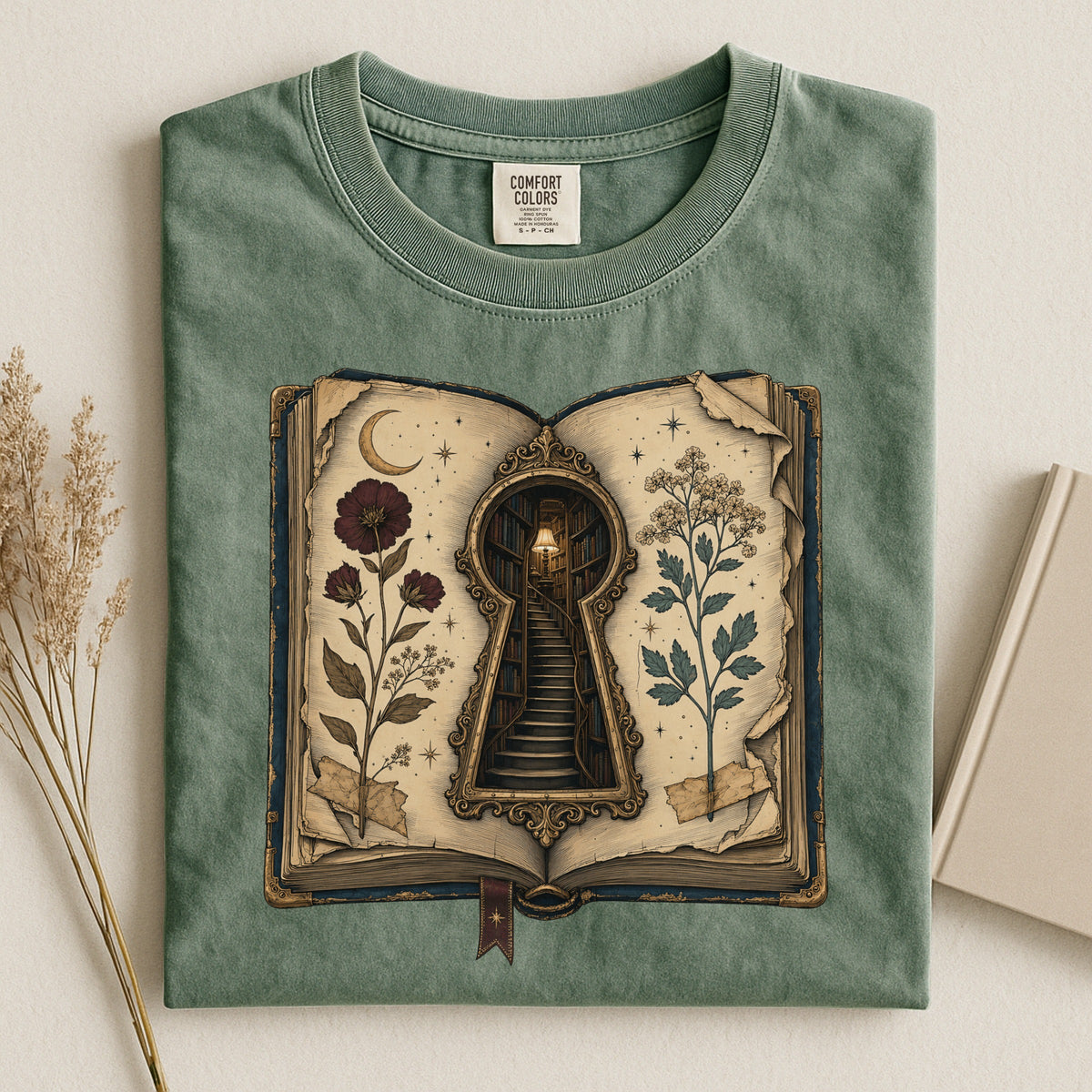 Shelf Love Studio Surreal Keyhole Book t-shirt in Moss, styled flat lay