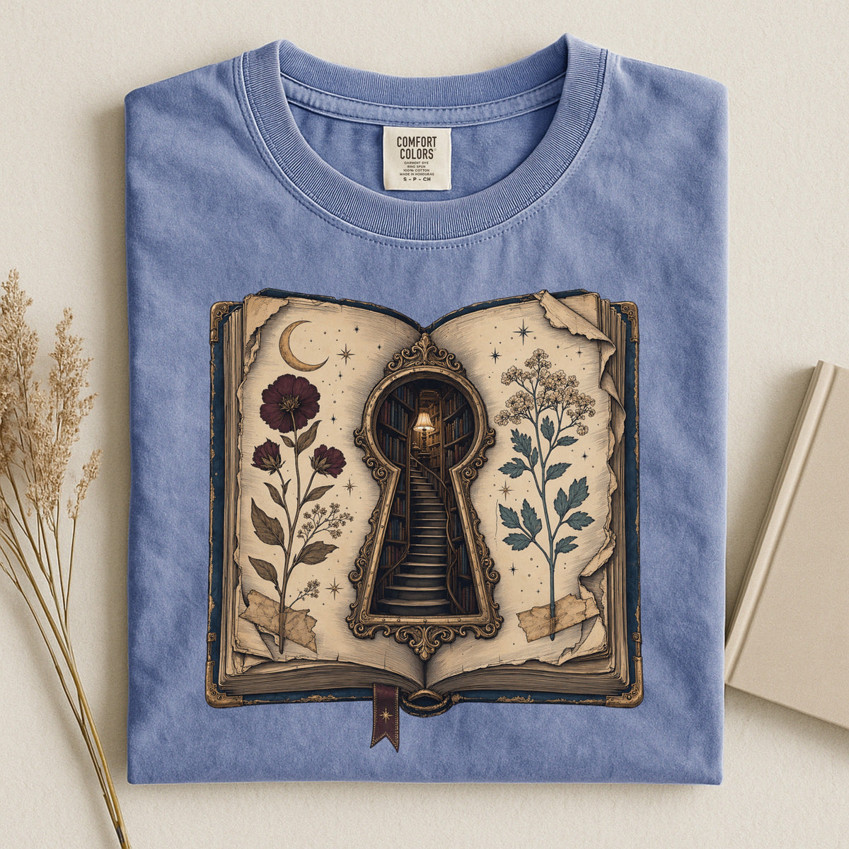 Shelf Love Studio Surreal Keyhole Book t-shirt in Blue Jean, styled flat lay