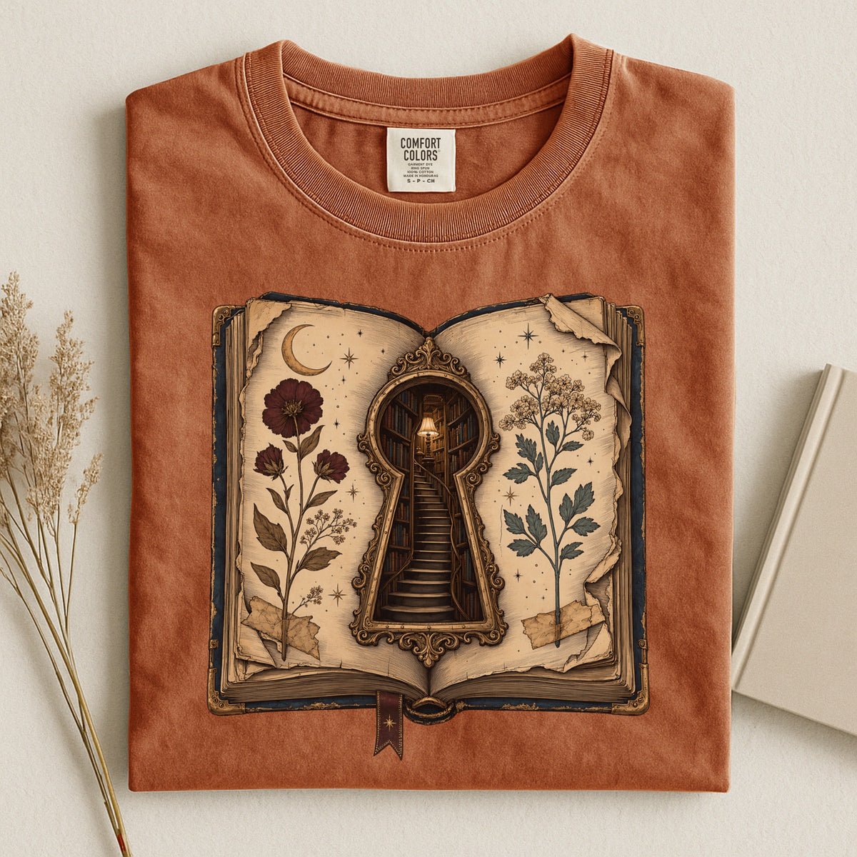 Shelf Love Studio Surreal Keyhole Book t-shirt in Yam, styled flat lay