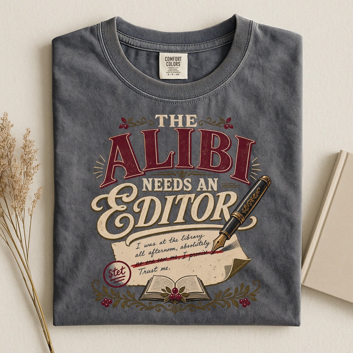 The Alibi Needs an Editor bookish tee in Pepper, flat lay