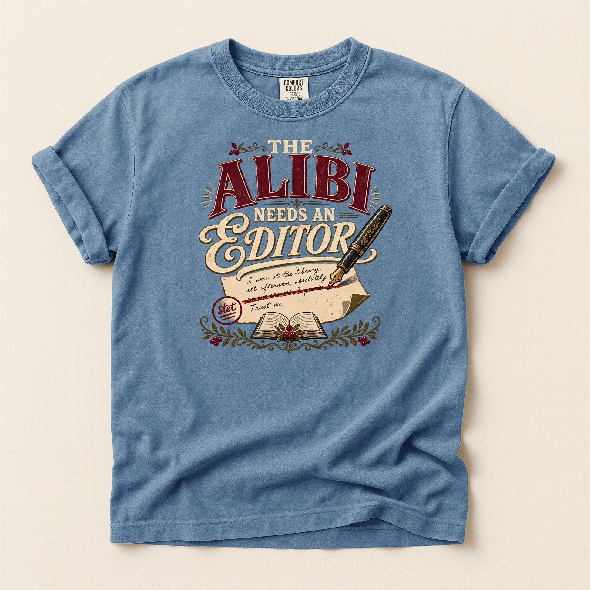 The Alibi Needs an Editor bookish tee in Blue Jean, full flat