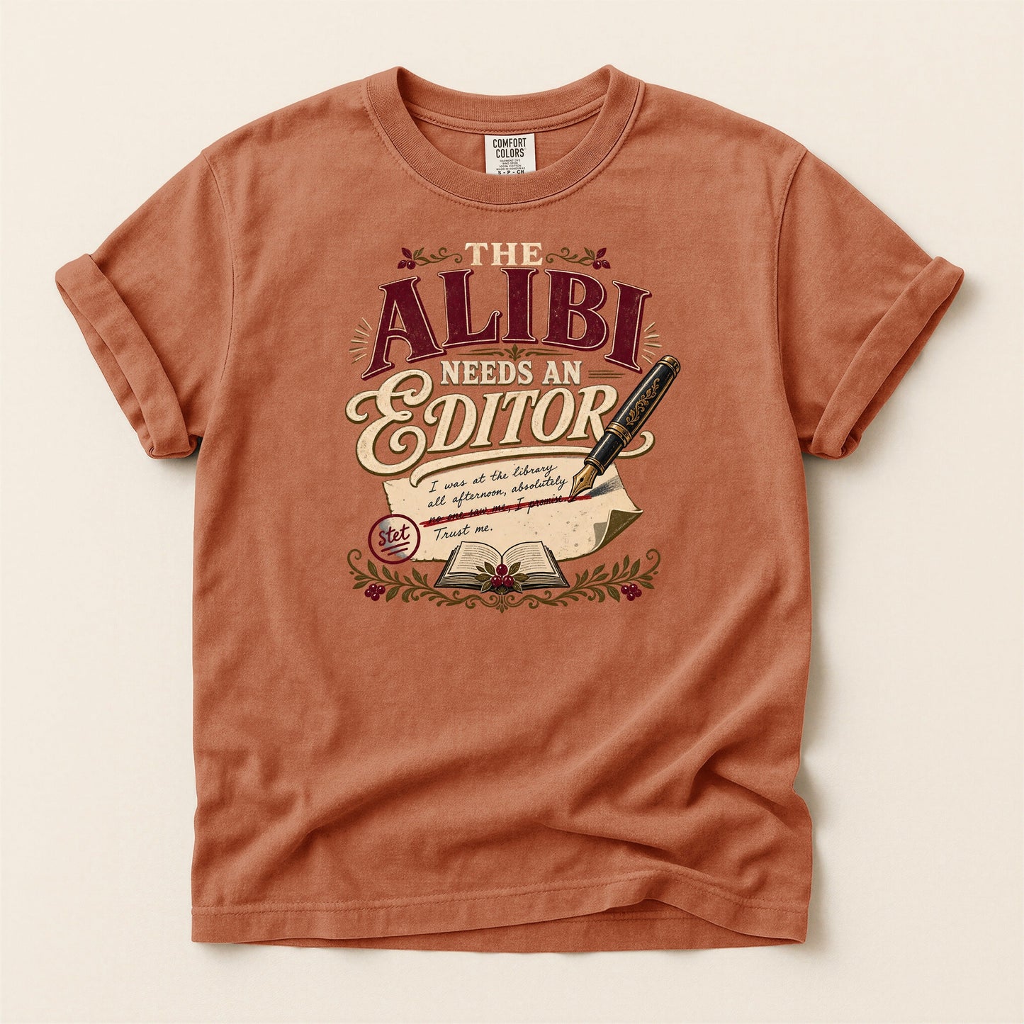 The Alibi Needs an Editor bookish tee in Yam, full flat