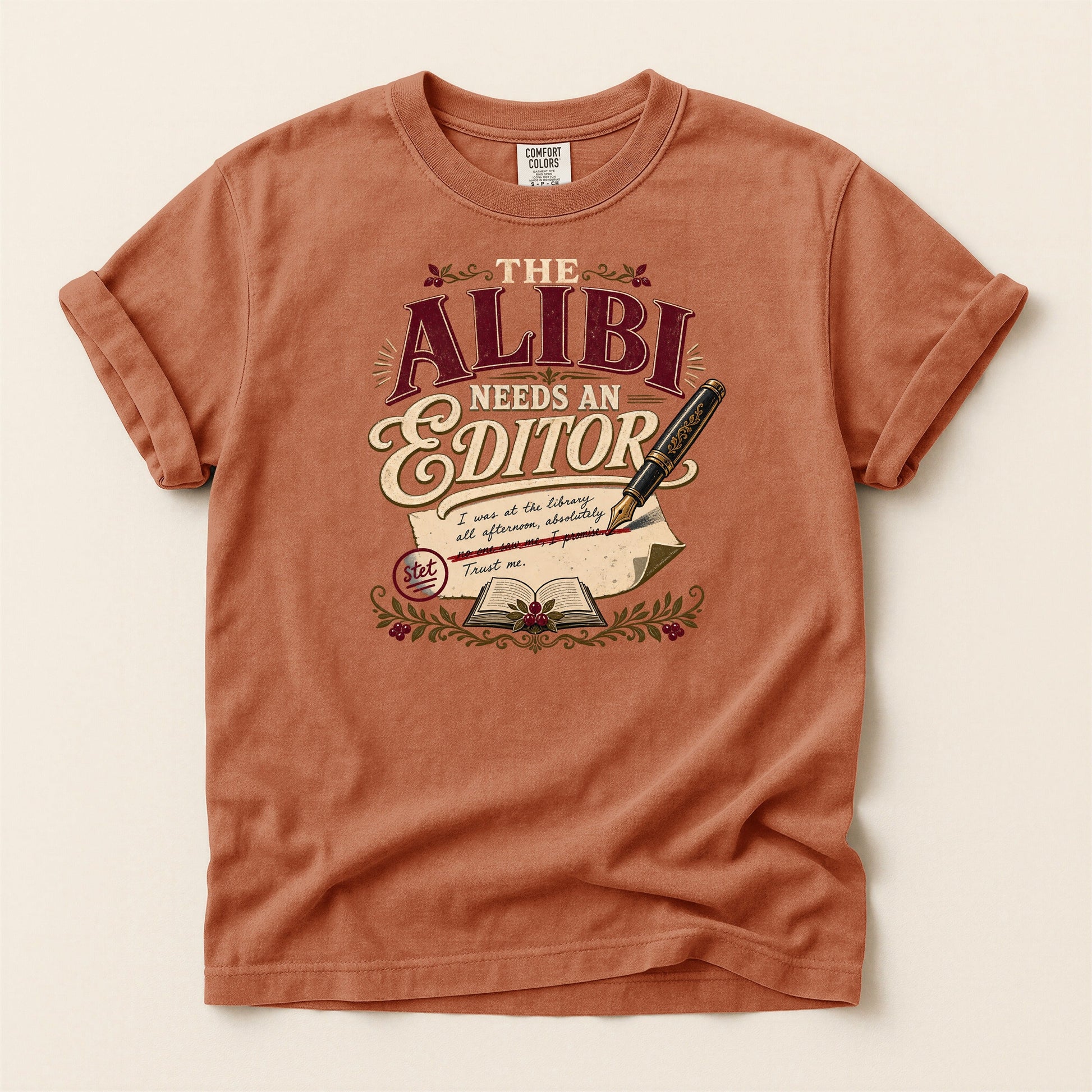 The Alibi Needs an Editor bookish tee in Yam, full flat