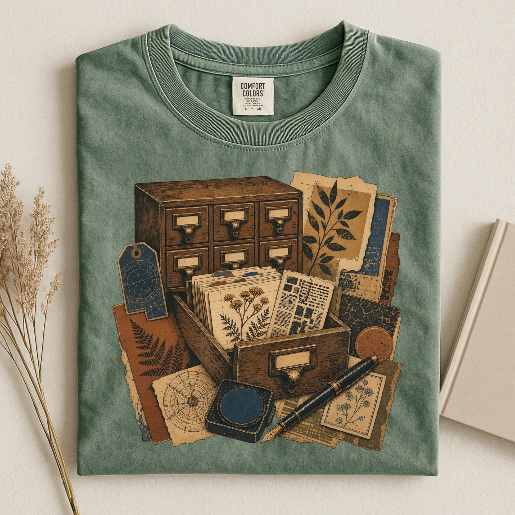 The Card Catalog bookish tee in Moss, flat lay