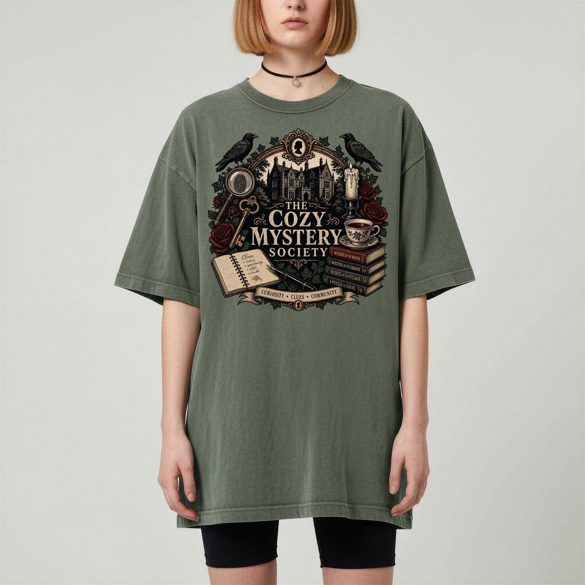 The Cozy Mystery Society bookish tee in Moss, worn