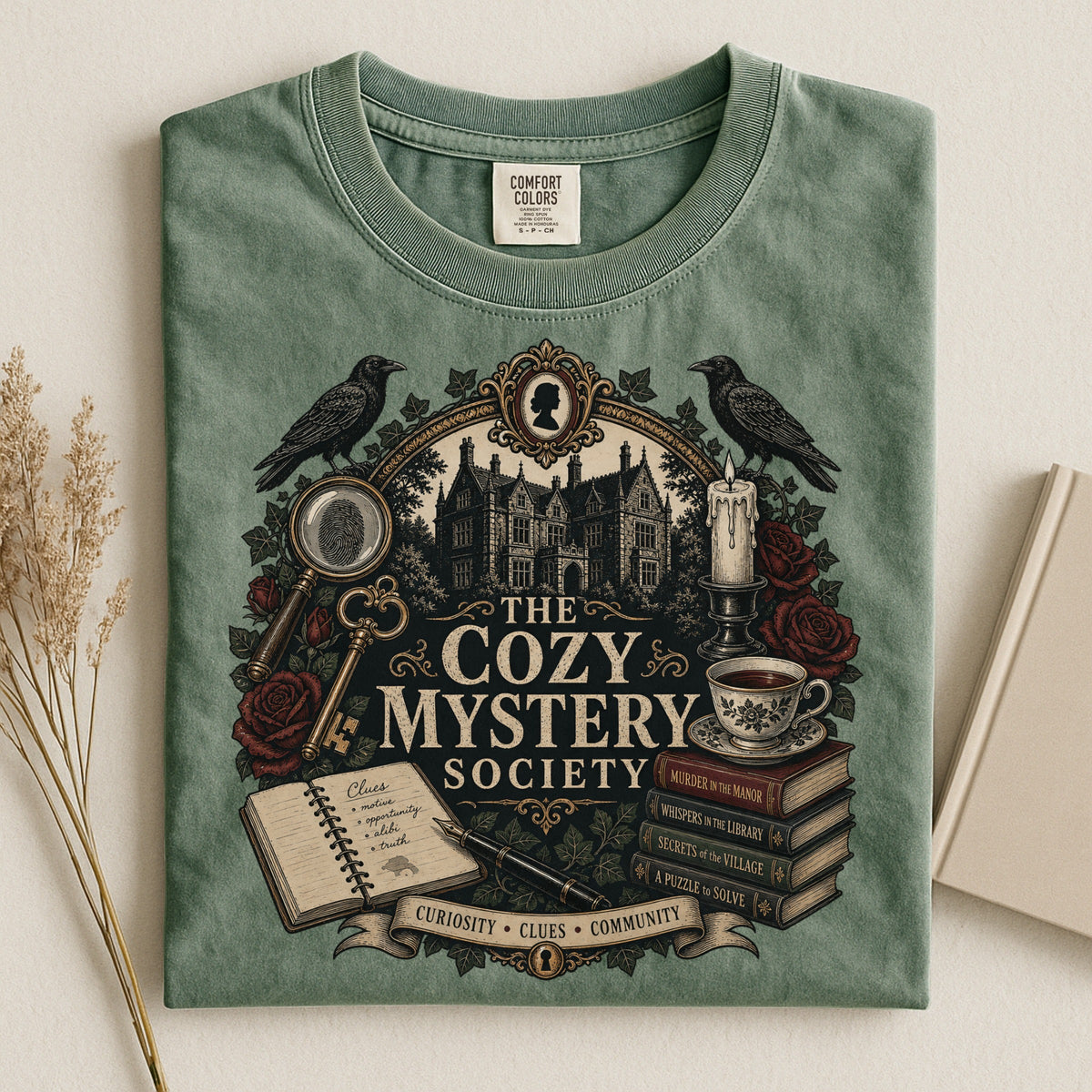 The Cozy Mystery Society bookish tee in Moss, flat lay