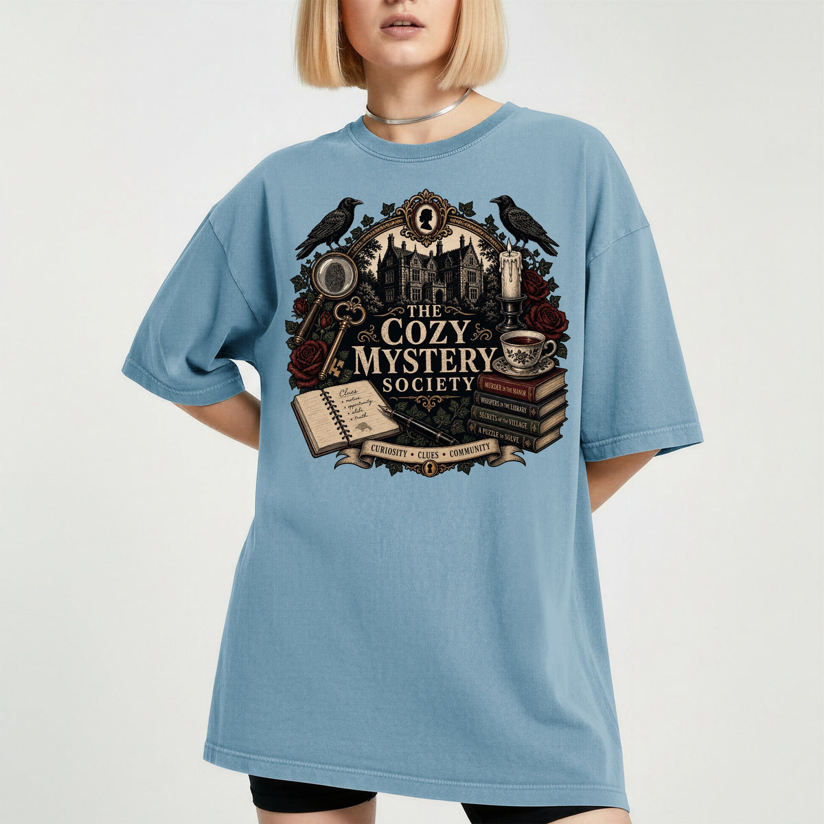The Cozy Mystery Society bookish tee in Ice Blue, worn