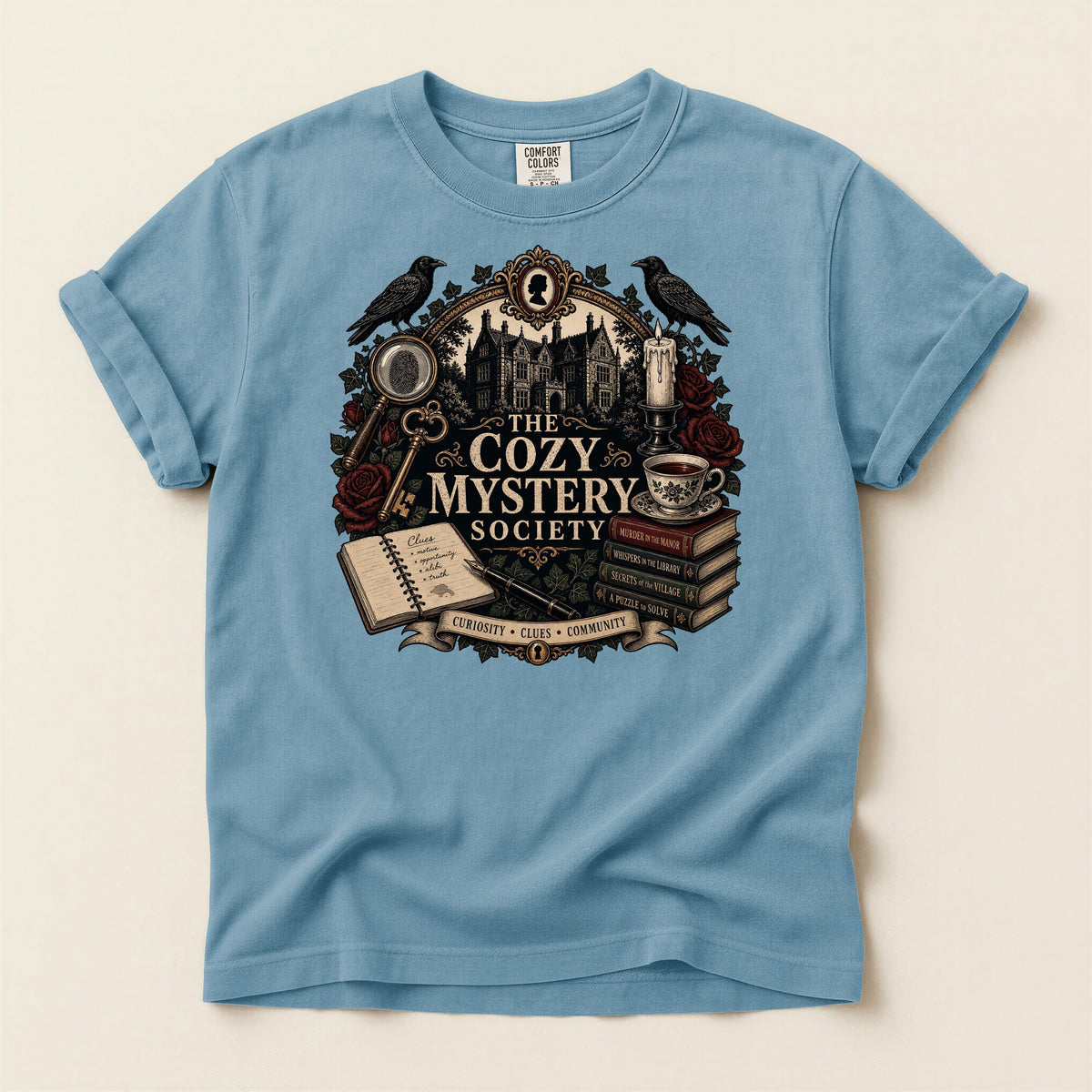 The Cozy Mystery Society bookish tee in Ice Blue, full flat