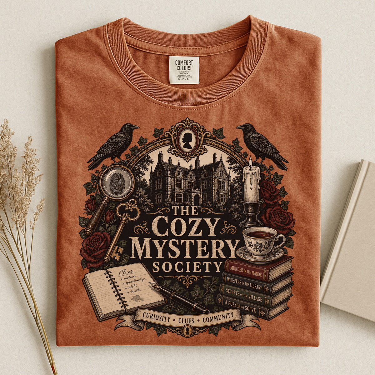 The Cozy Mystery Society bookish tee in Yam, flat lay