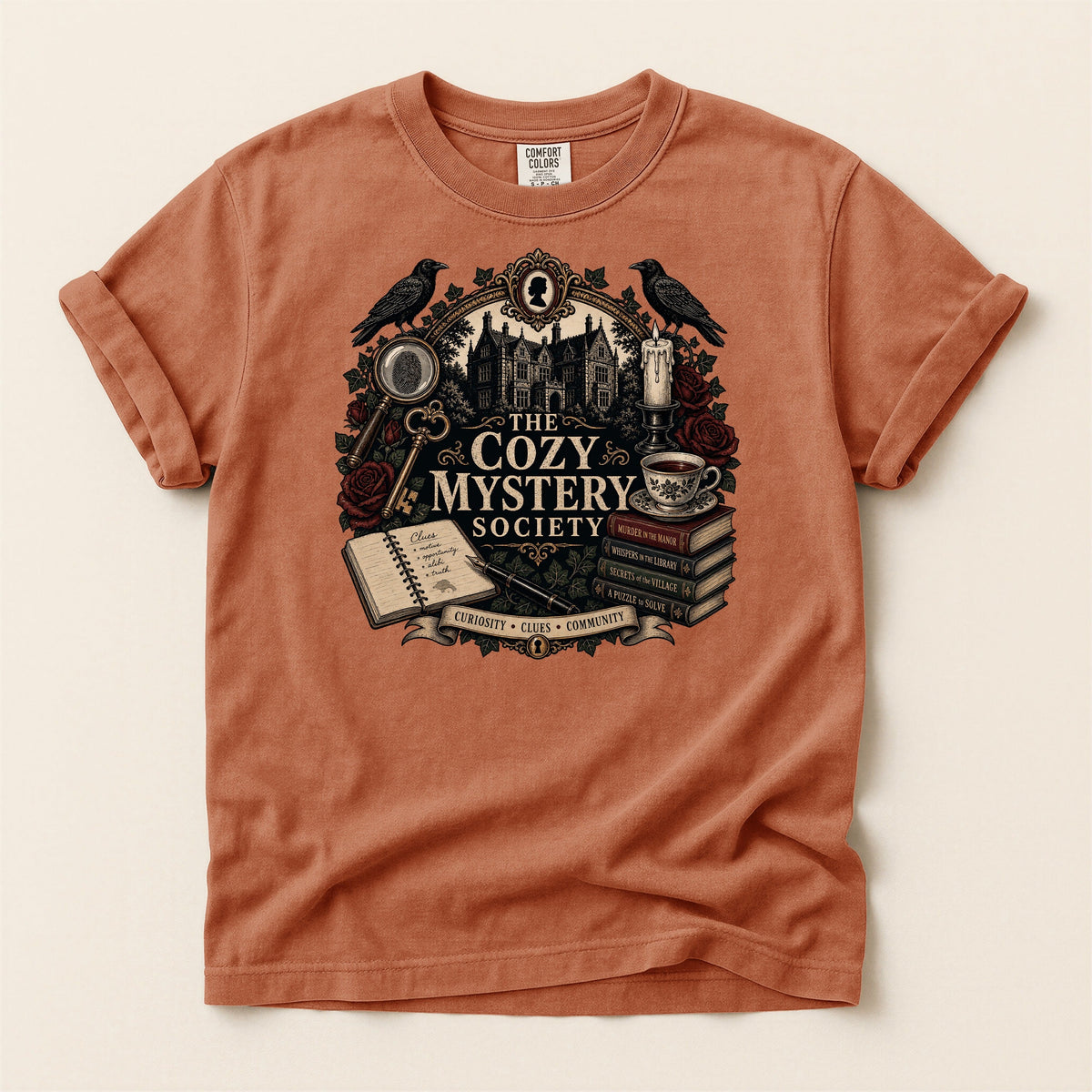 The Cozy Mystery Society bookish tee in Yam, full flat