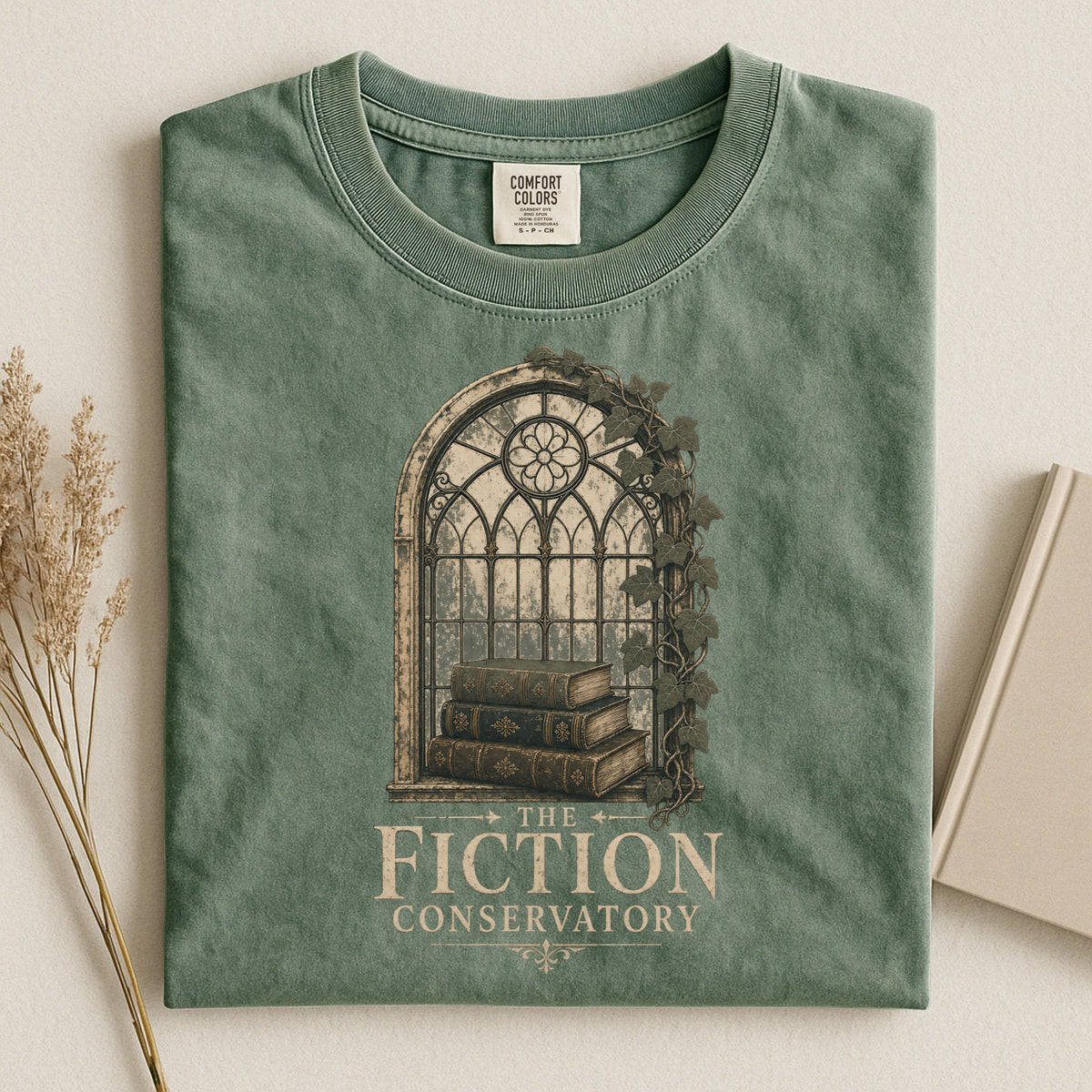 Shelf Love Studio The Fiction Conservatory t-shirt in Moss, styled flat lay