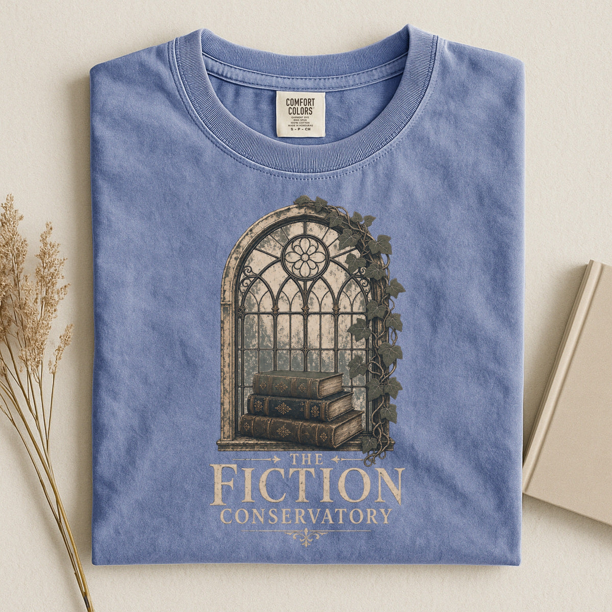 Shelf Love Studio The Fiction Conservatory t-shirt in Blue Jean, styled flat lay