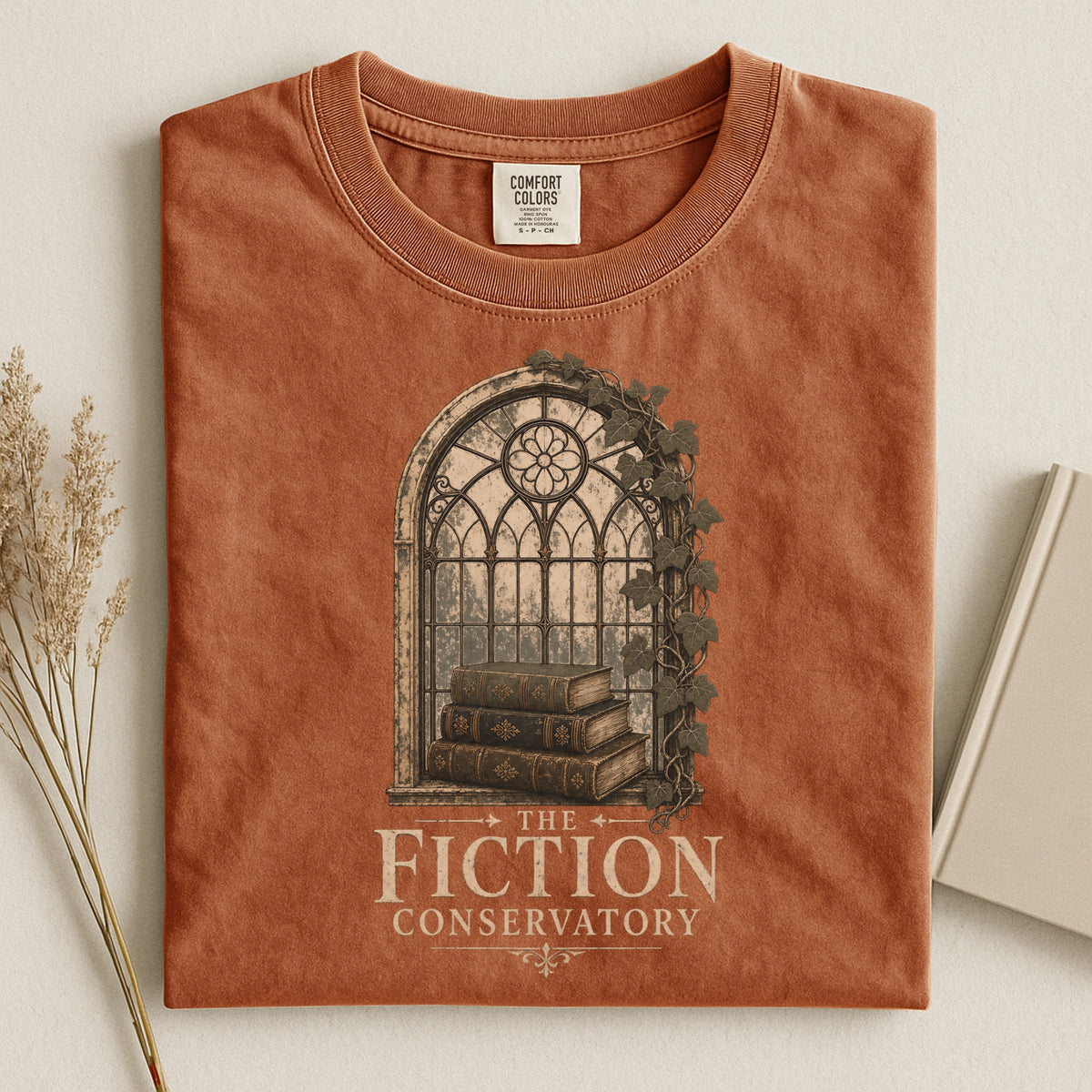 Shelf Love Studio The Fiction Conservatory t-shirt in Yam, styled flat lay