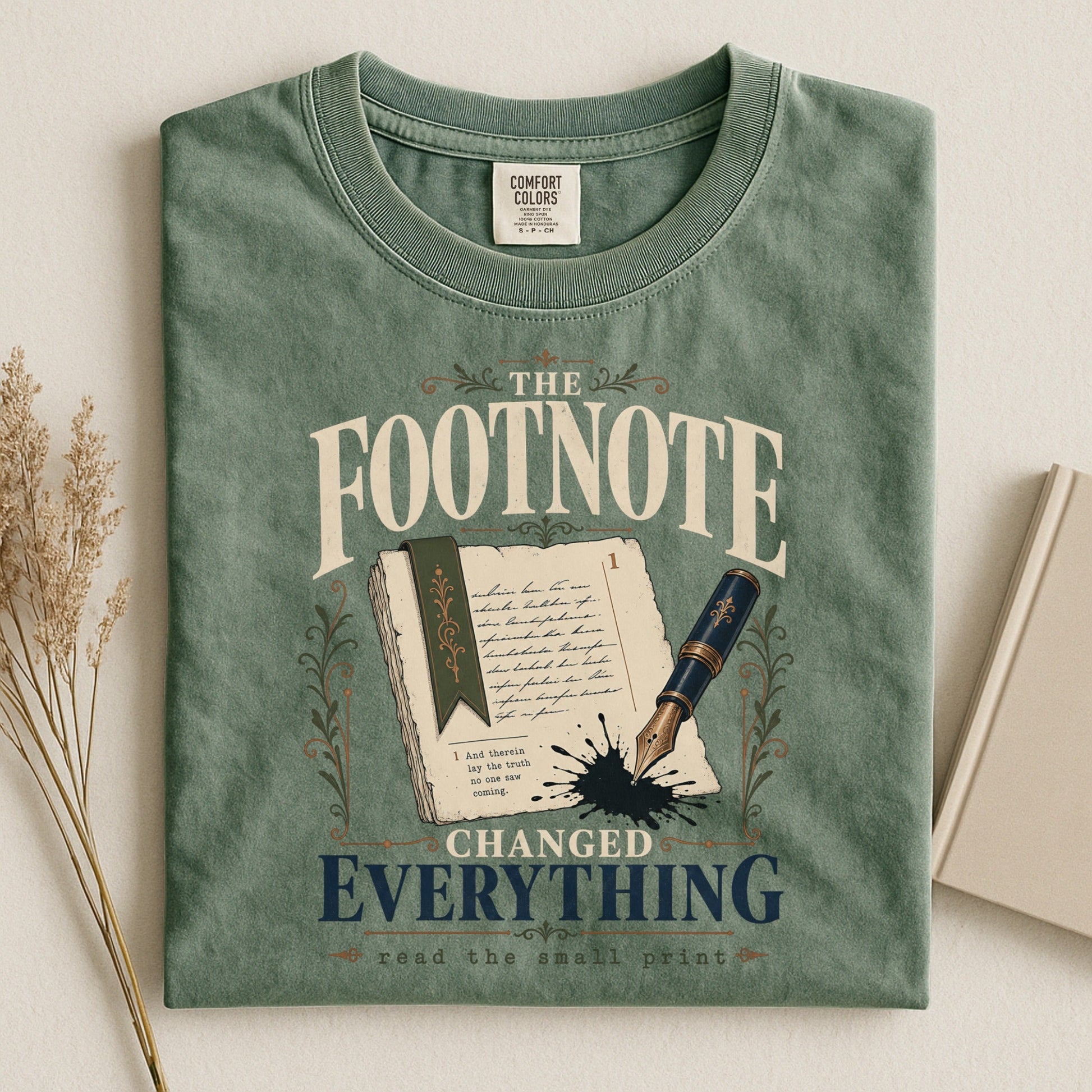 The Footnote Changed Everything bookish tee in Moss, flat lay