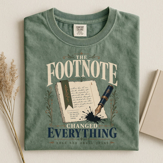 The Footnote Changed Everything bookish tee in Moss, flat lay