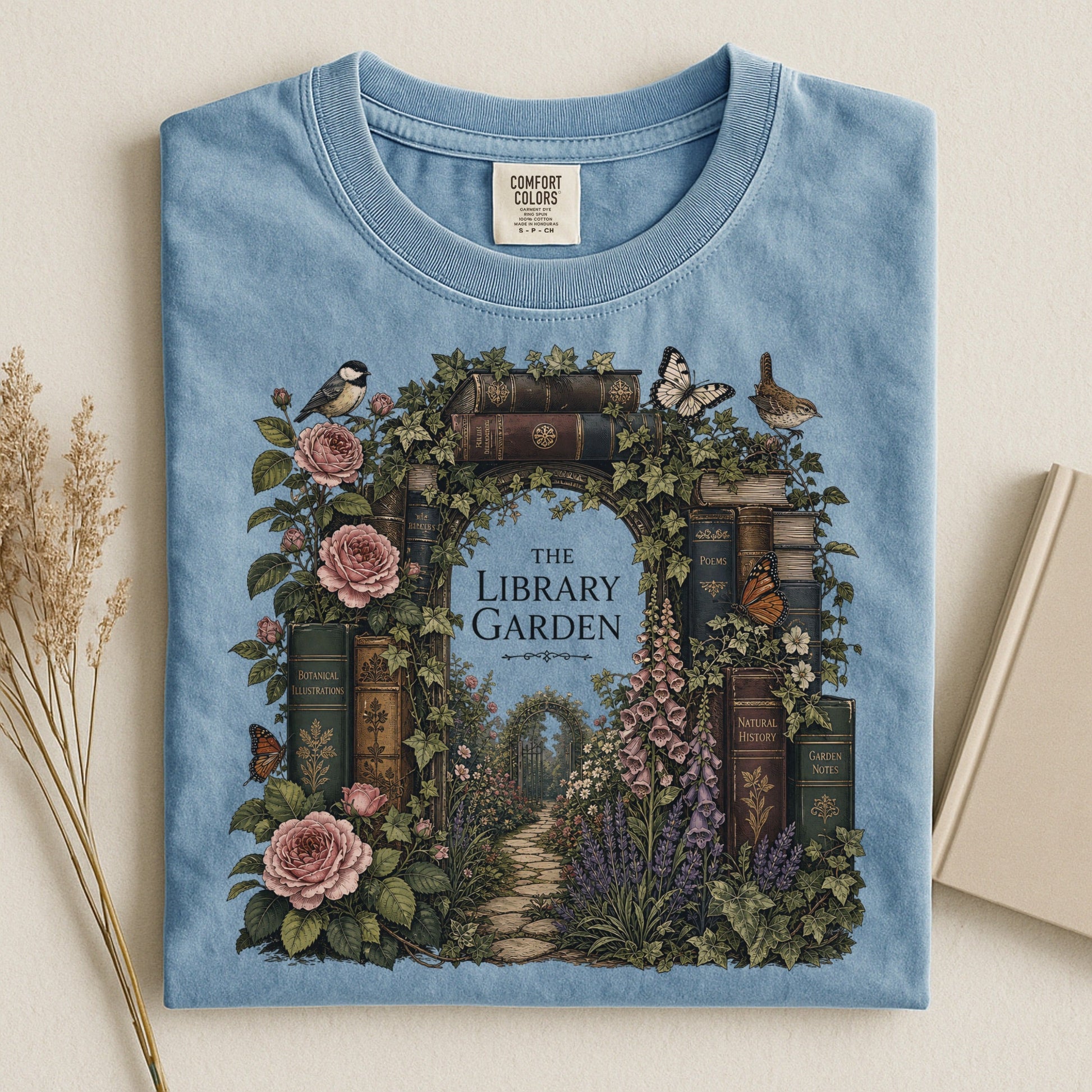 The Library Garden bookish tee in Ice Blue, flat lay
