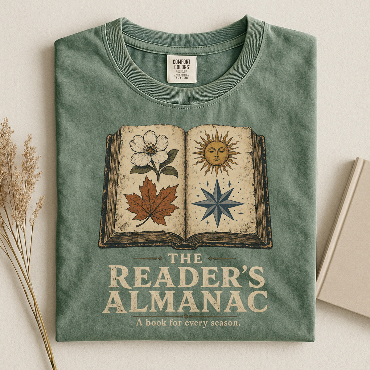 Shelf Love Studio The Reader's Almanac t-shirt in Moss, styled flat lay