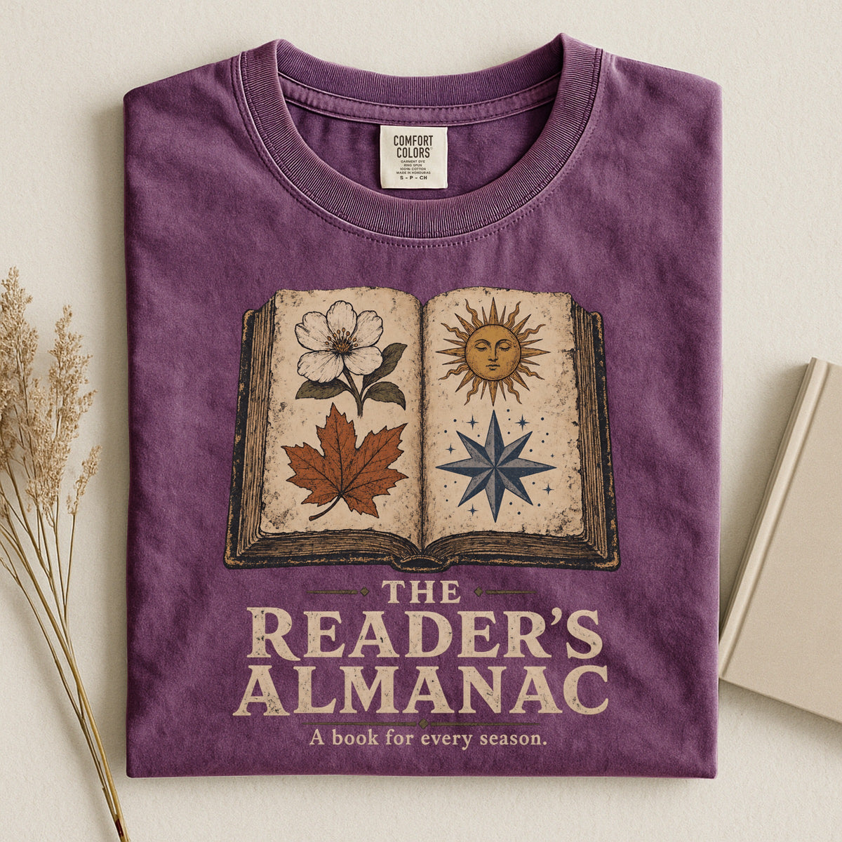 Shelf Love Studio The Reader's Almanac t-shirt in Berry, styled flat lay