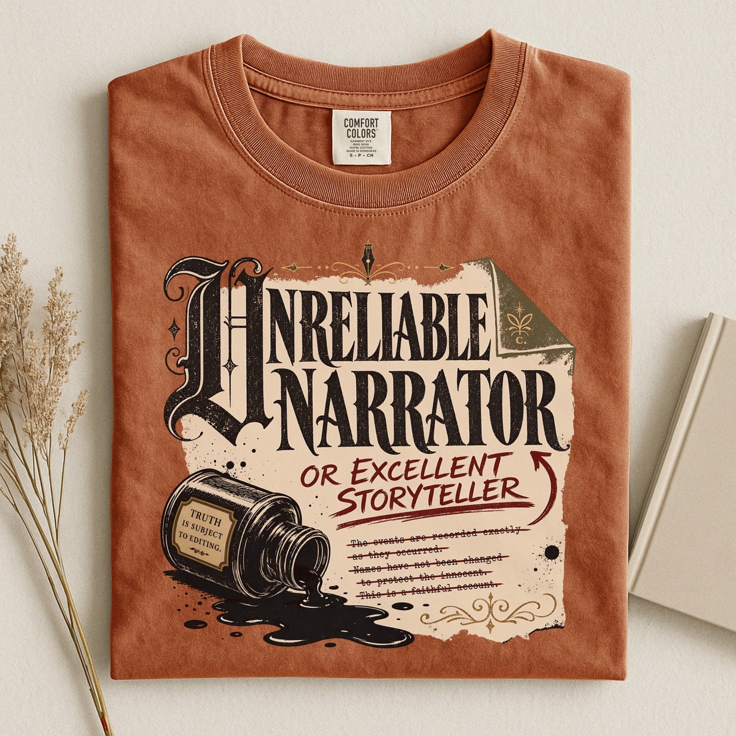Shelf Love Studio Unreliable Narrator t-shirt in Yam, styled flat lay