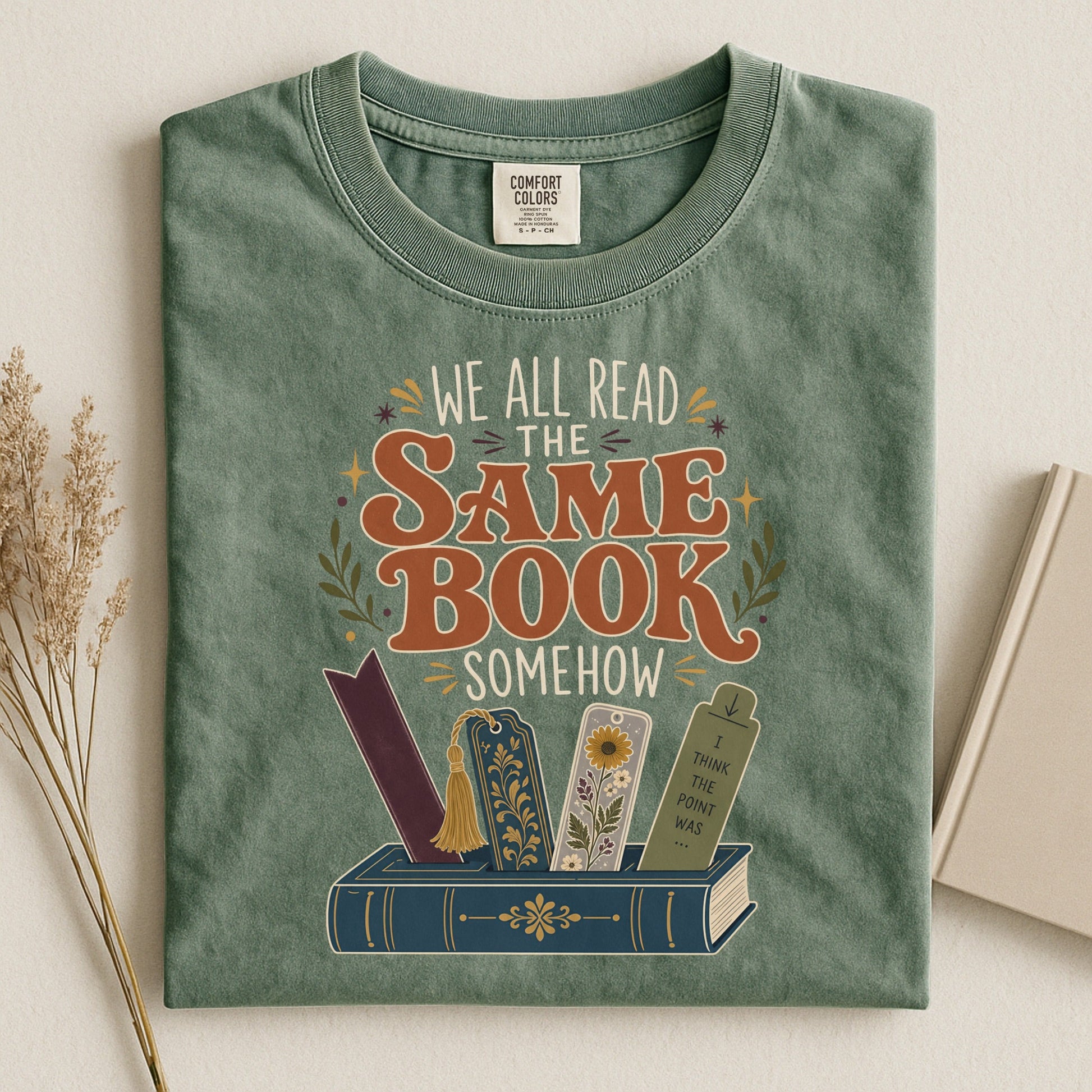 We All Read the Same Book Somehow bookish tee in Moss, flat lay