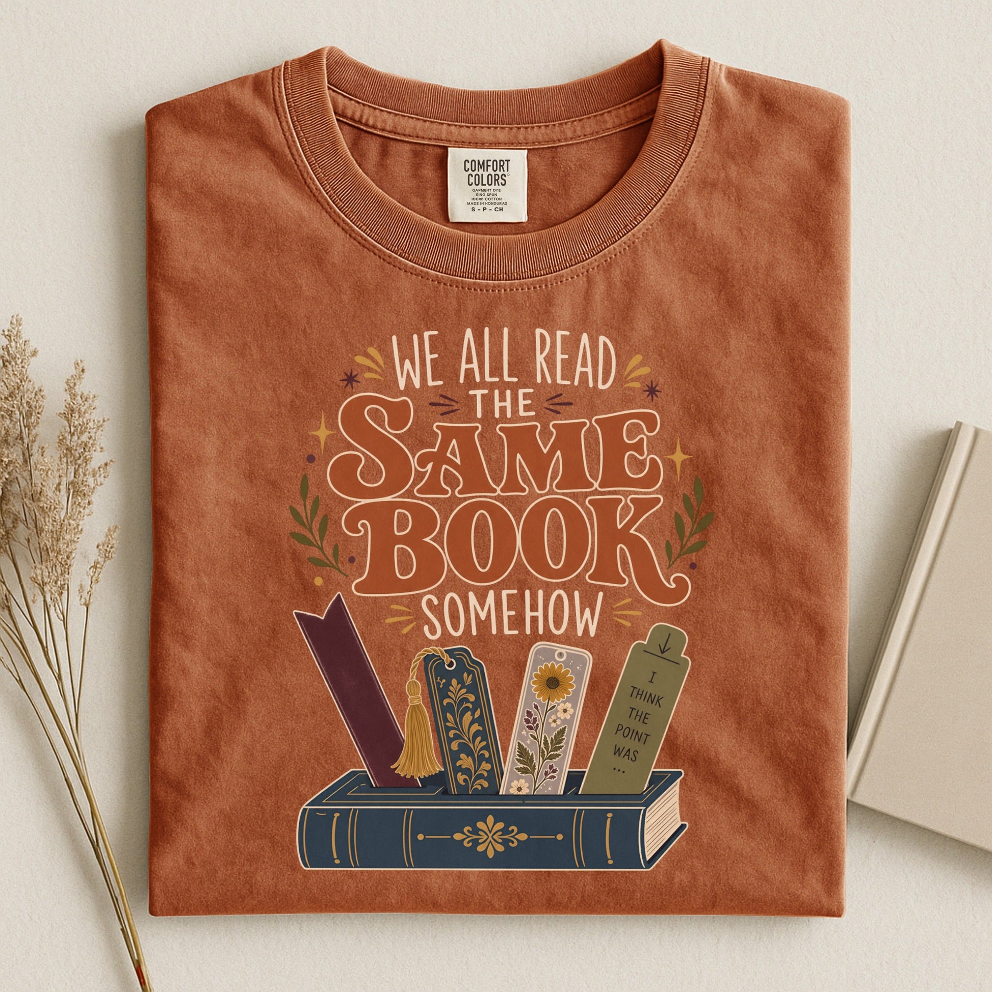 We All Read the Same Book Somehow bookish tee in Yam, flat lay