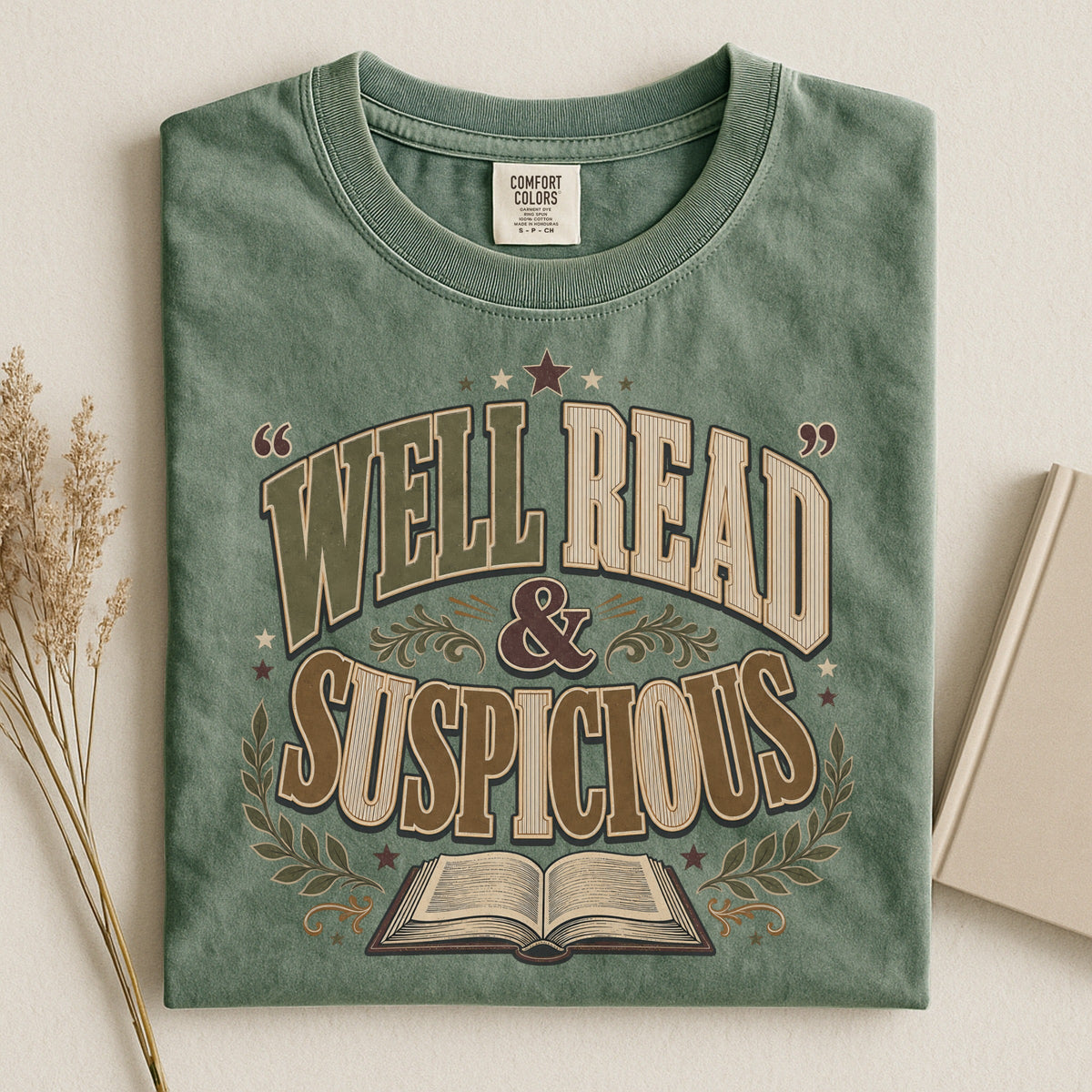 Shelf Love Studio Well Read & Suspicious t-shirt in Moss, styled flat lay