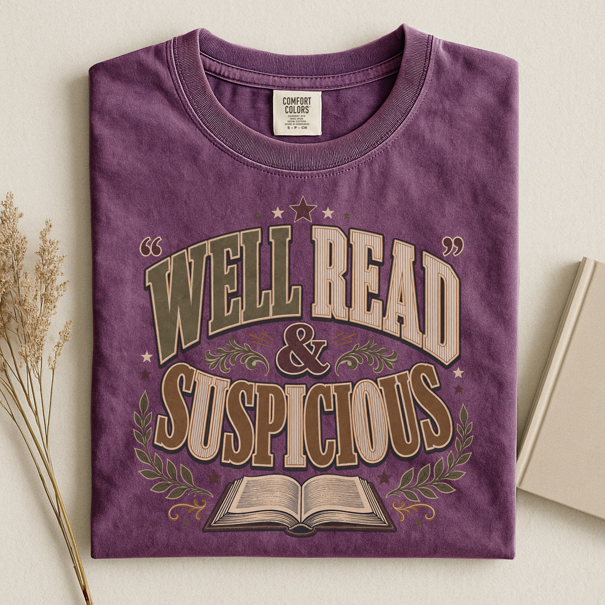 Shelf Love Studio Well Read & Suspicious t-shirt in Berry, styled flat lay