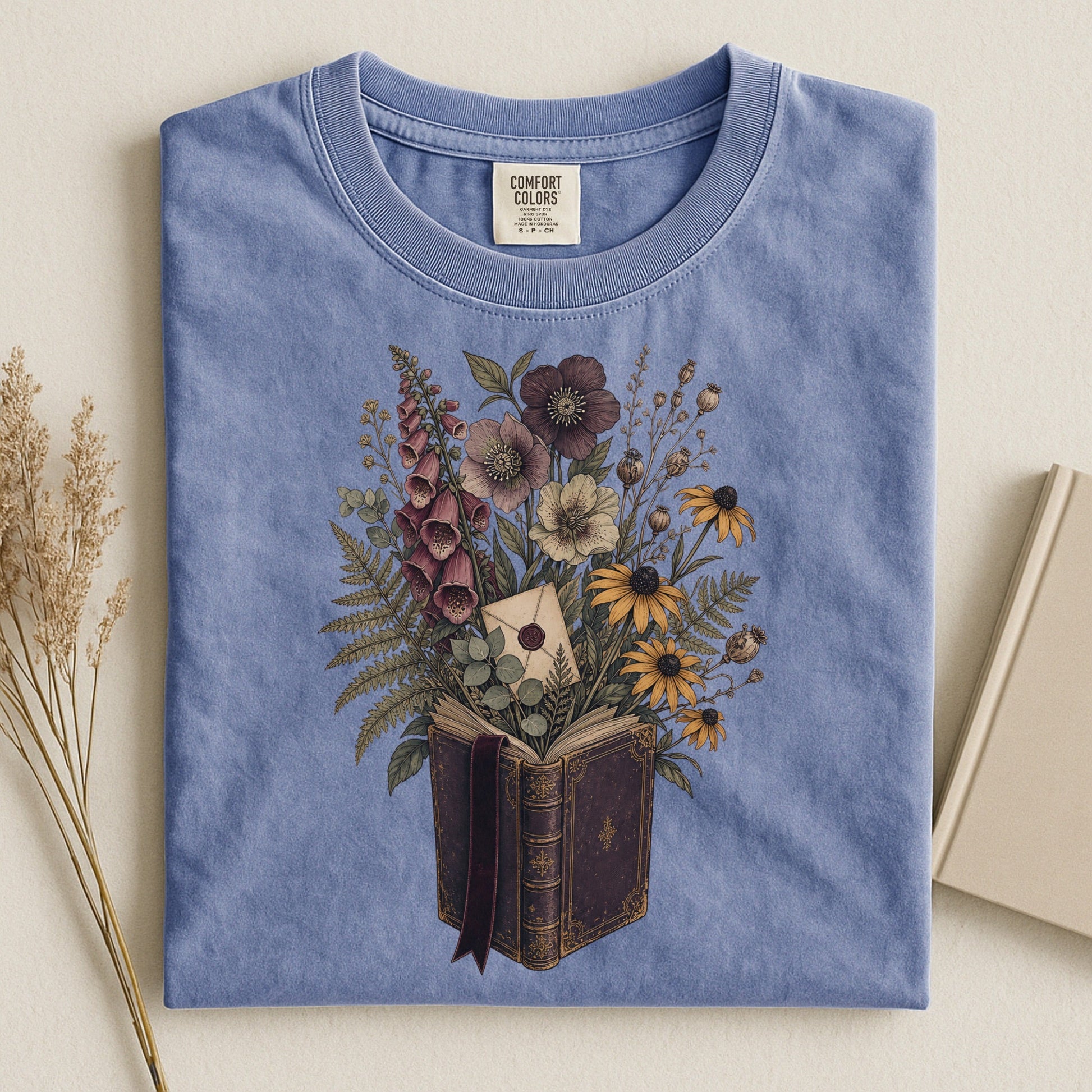 Wildflower Book Bouquet bookish tee in Blue Jean, flat lay