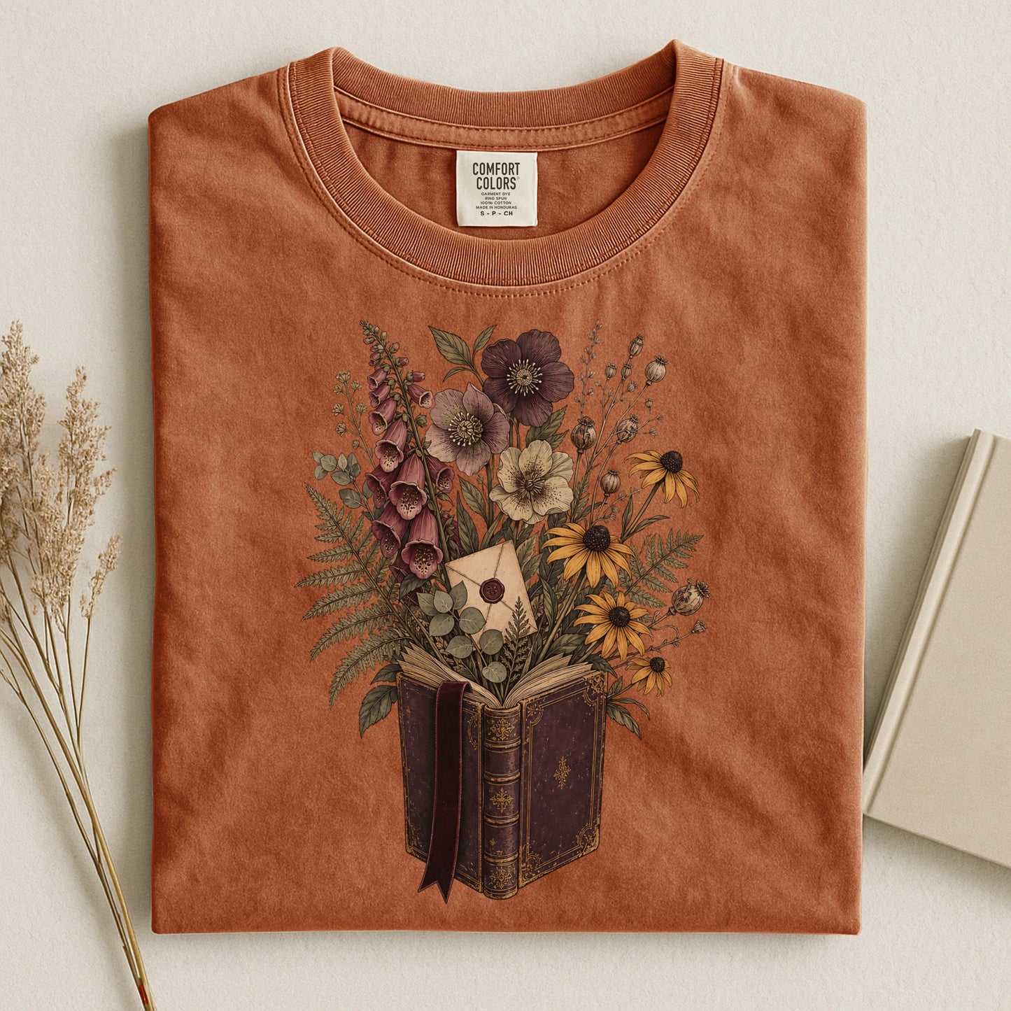 Wildflower Book Bouquet bookish tee in Yam, flat lay