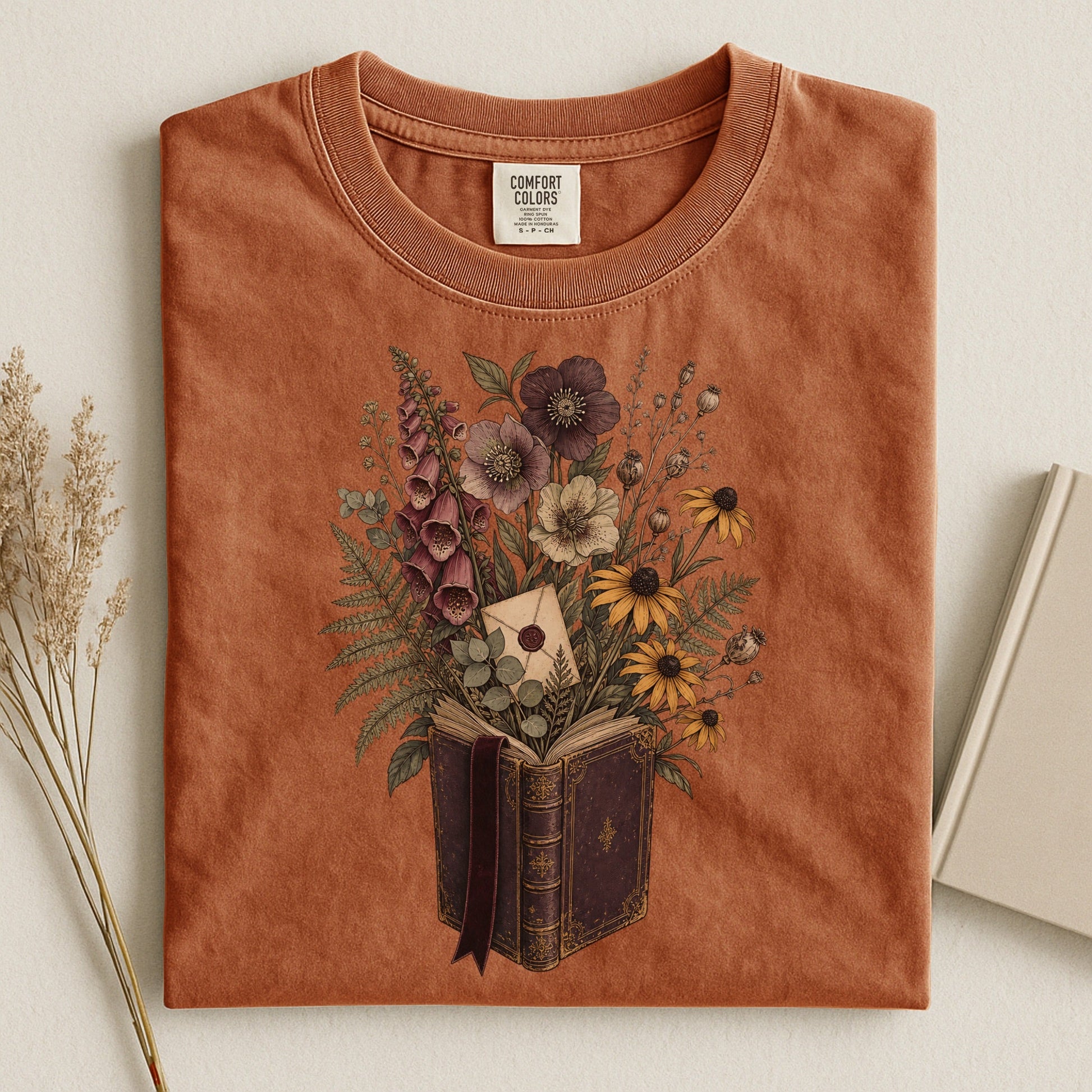 Wildflower Book Bouquet bookish tee in Yam, flat lay